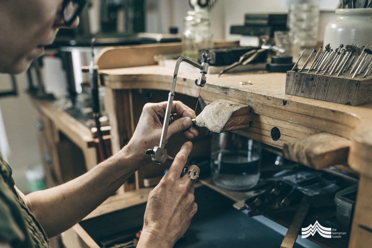 Tony Gilbett using hacksaw in jewellery workshop