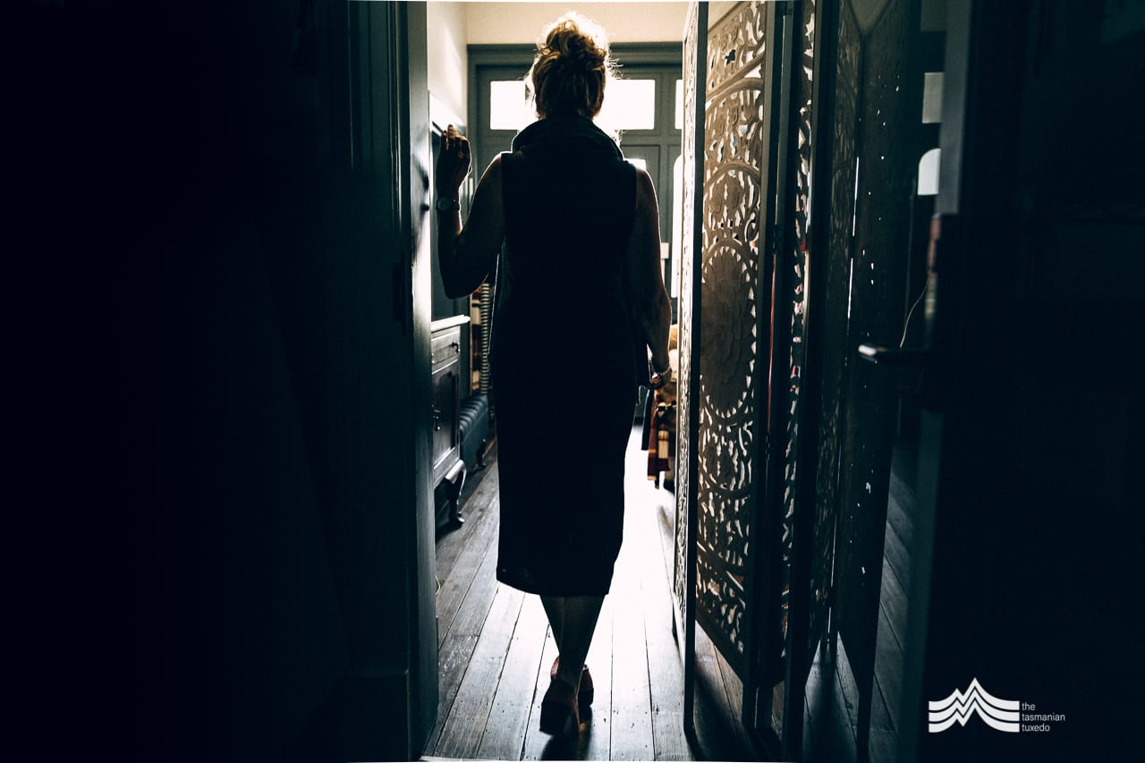Nicola walking through a doorway in silhouette