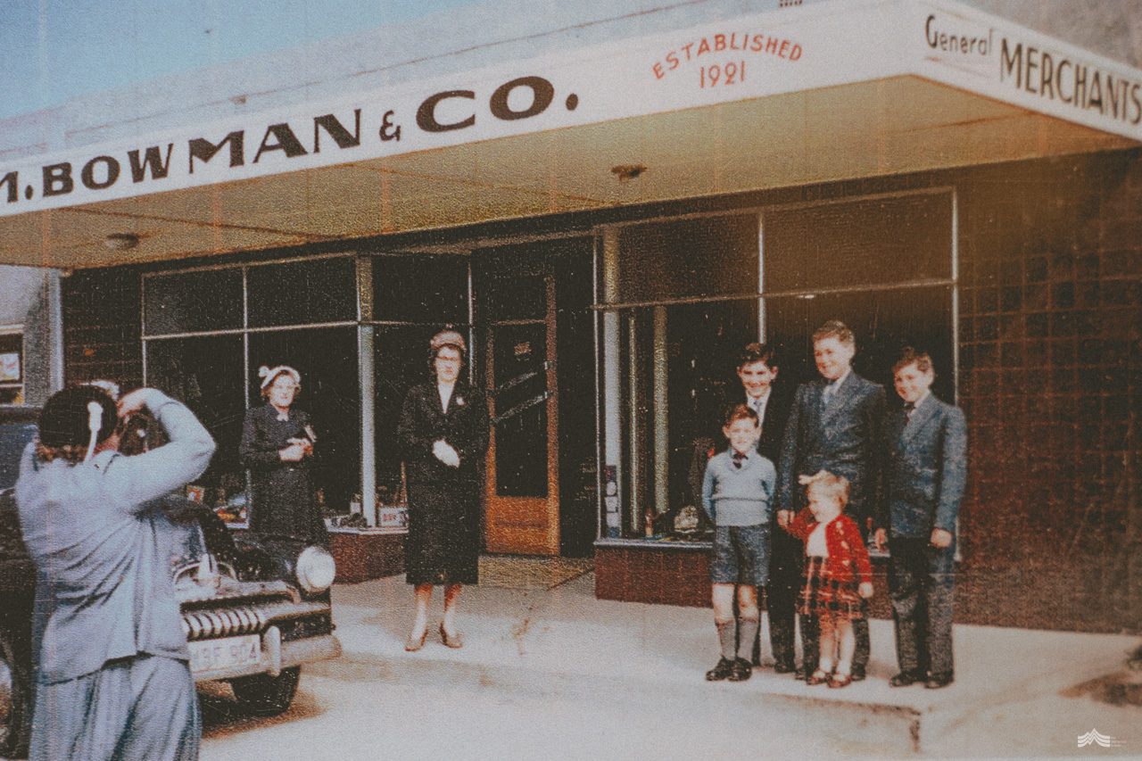 The shopfront in the mid 20th century with family posing outside